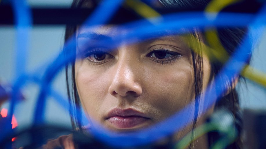 An engineer seen through blue network cables