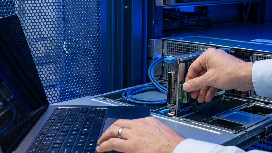 Hands seating a component in an open server