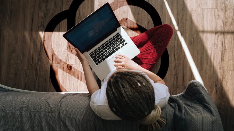 A person working on a laptop, seen from above
